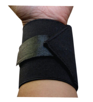 Black wrist support brace with Velcro strap secured around the wrist on a forearm, providing compression and stabilization